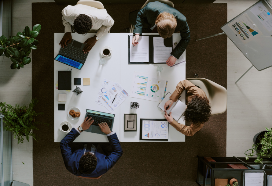 An overhead shot of a team collaborating on a strategy
