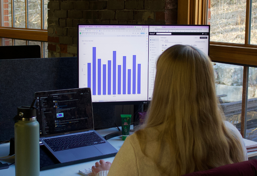 Woman looking at a graph on the screen in front of her.