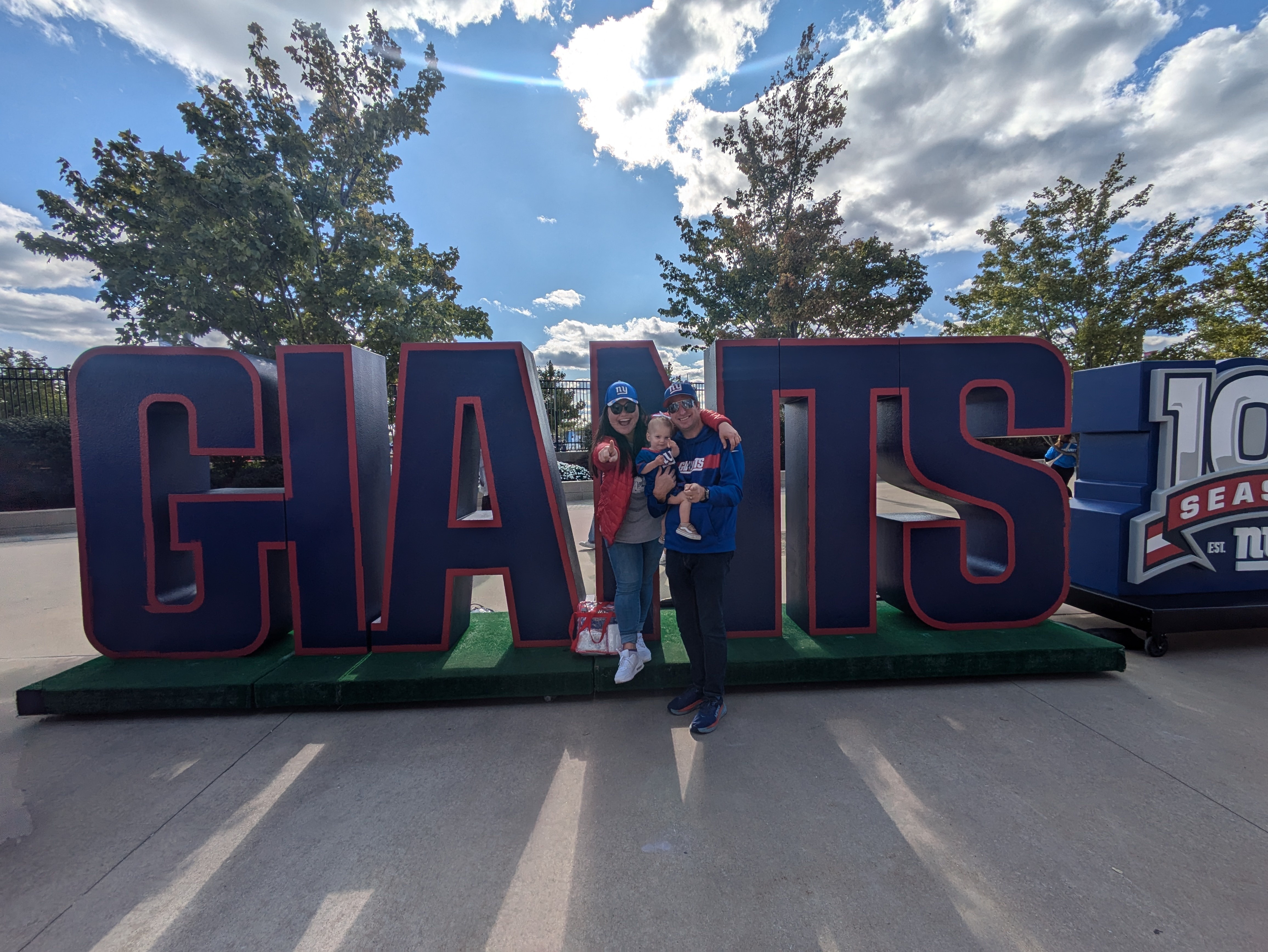 Matt and Ashley in front of a large sign reading GIANTS.