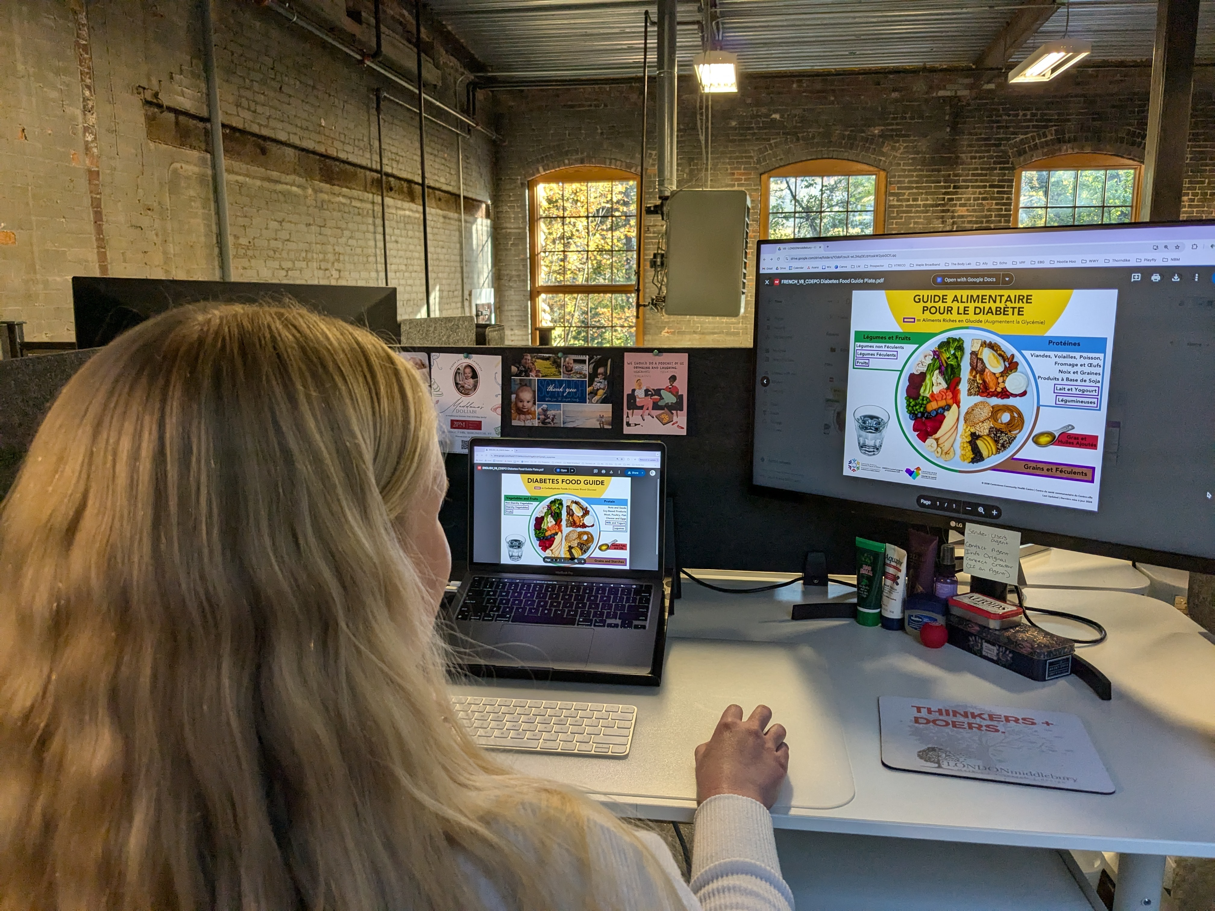 Team member looking at the English and French version of a diabetes food guide.